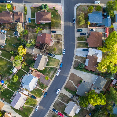 An ariel image of houses and cars on a street