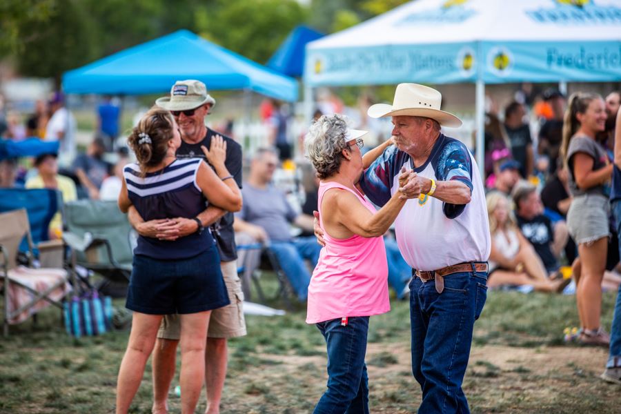 Couples dancing to live music at a Miners Day festival.