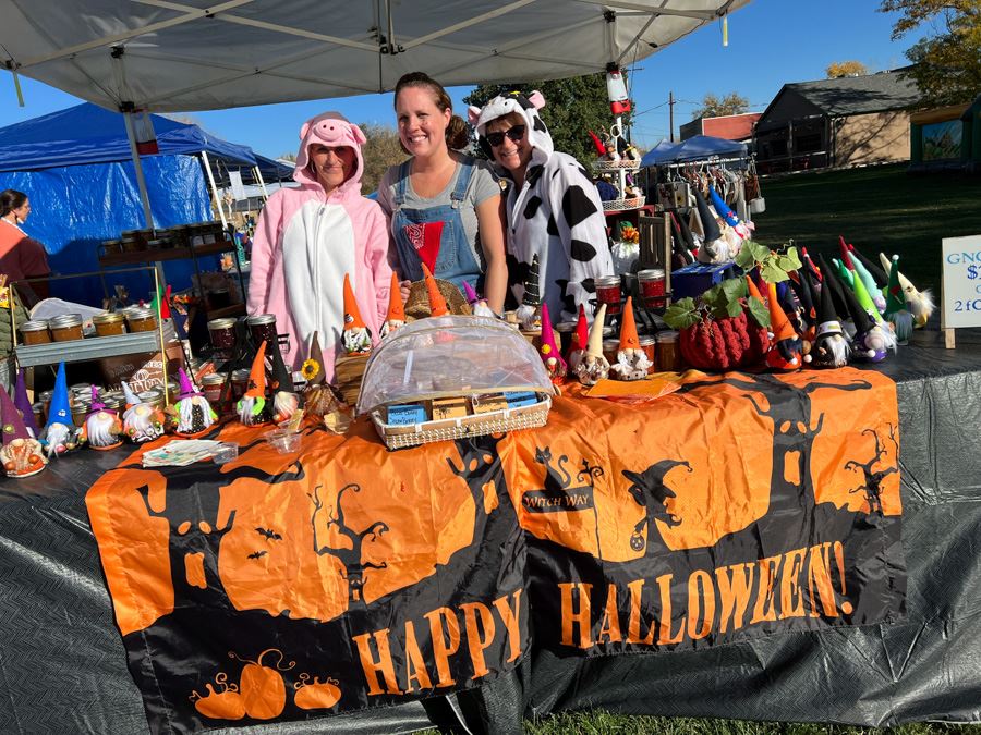 Vendors dressed in costumes at Tiny Terror Town Halloween market.