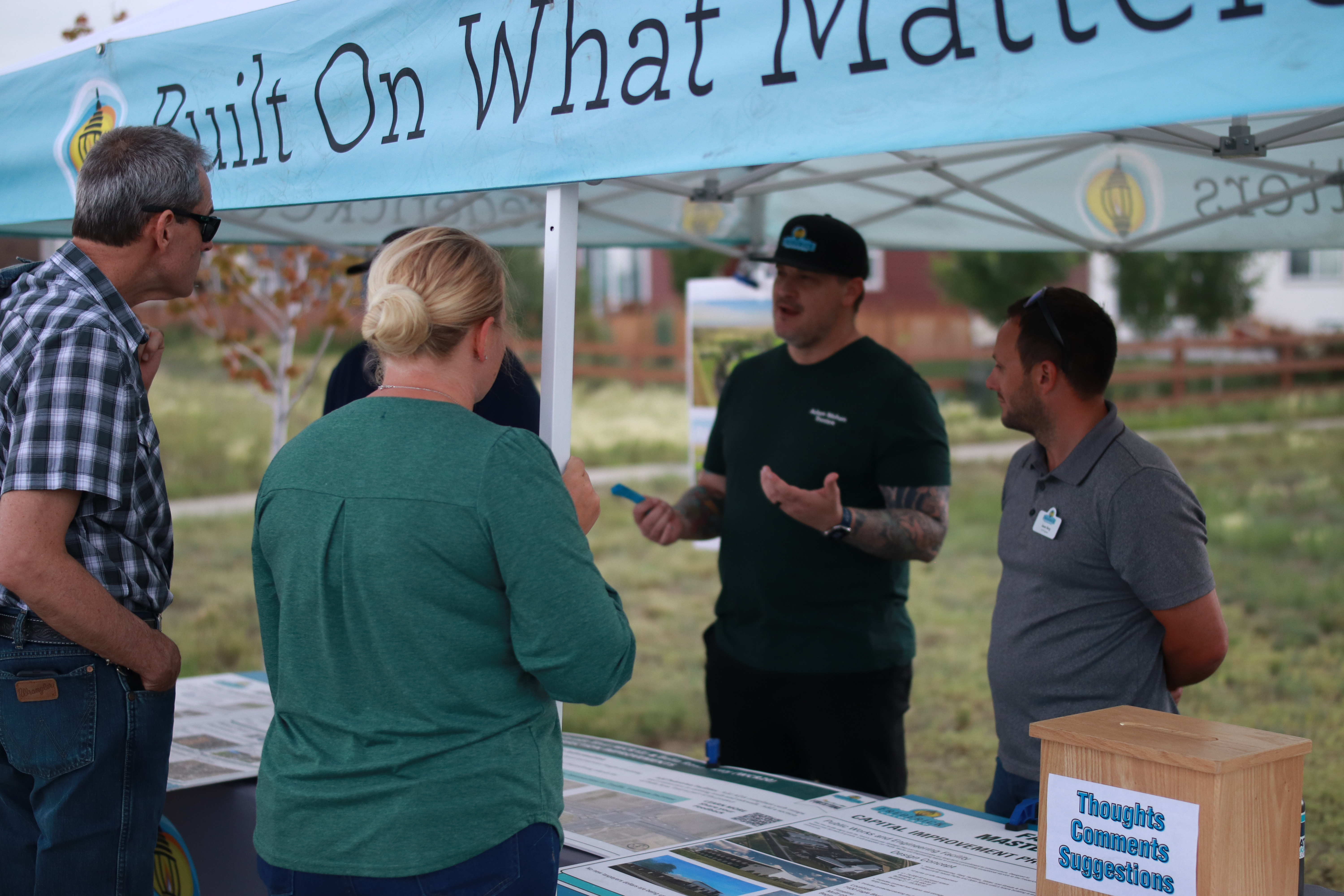 A couple of town employees interacting with residents